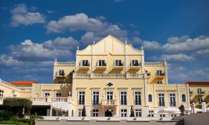 a white building with a balcony on top of it at Domes Lake Algarve, Autograph Collection in Vilamoura