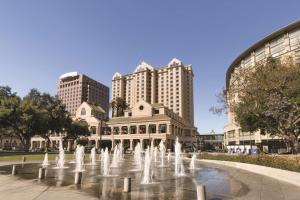 a fountain in front of a building with tall buildings at Signia by Hilton San Jose in San Jose