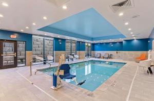 a pool in a hotel room with a pool at Hampton Inn Colorado Springs Northeast in Colorado Springs
