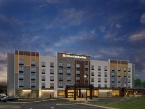 un edificio de hotel con un letrero iluminado en él en Hilton Garden Inn Jeffersonville, In, en Jeffersonville
