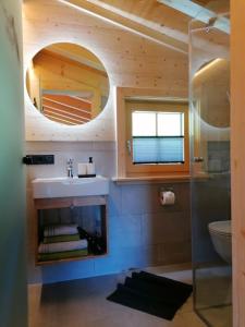a bathroom with a sink and a mirror at Almchalet Wieslhütte in Gerlosberg