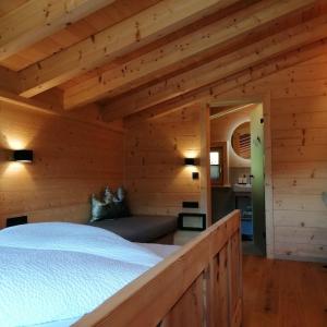 a bedroom with a bed in a log cabin at Almchalet Wieslhütte in Gerlosberg