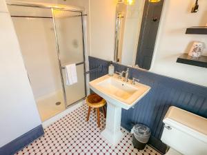 a bathroom with a sink and a shower at Beachliner Hotel in Ocean Grove