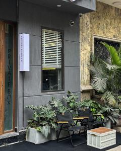 a group of tables and chairs outside of a building at Lux Westlake Studio in Hanoi