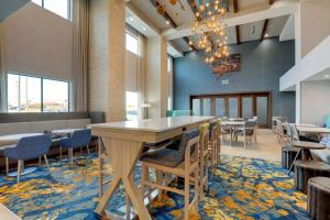 a dining room with tables and chairs and a chandelier at Hampton Inn & Suites Weatherford, Tx in Weatherford