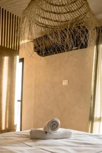 a towel laying on a bed in a room at Dawar Sinai Bliss - Luxury Haven in Ma'ale Adumim