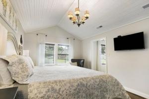 a bedroom with a bed and a flat screen tv at Mill Stream Cottage in Pigeon Forge