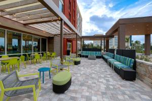 a patio with colorful chairs and tables and chairs at Home2 Suites By Hilton Lakewood Ranch in Bradenton