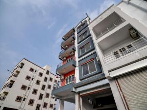 two tall white buildings with balconies on them at OYO Home Designer Stay Hinjewadi in Hinjewadi