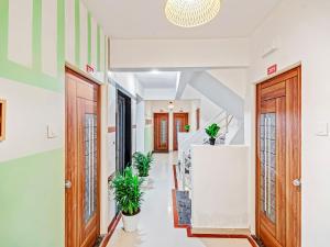 a hallway with two doors and potted plants at OYO Home Designer Stay Hinjewadi in Hinjewadi