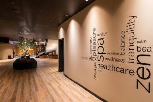 a lobby with a wall with words on it at HF Ipanema Park in Porto