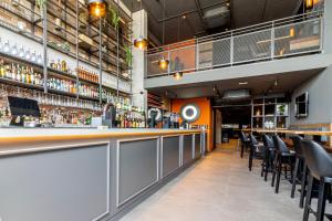 a bar in a restaurant with a lot of chairs at The Londoner Hotel Sliema in Sliema