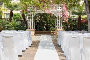a set up for a wedding ceremony with white chairs at Doubletree by Hilton Buena Park in Buena Park