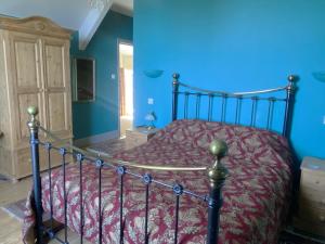 a bedroom with a bed with a red comforter at North Walk House in Lynton