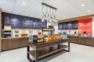 a fast food restaurant with a counter with food at Hampton Inn Kansas City Southeast, Mo in Kansas City