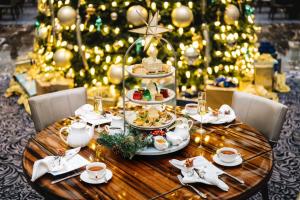 a christmas table with food and a christmas tree at Waldorf Astoria Washington DC in Washington