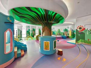 a childrens play area with a tree on the ceiling at Doubletree By Hilton Taizhou Shenxianju in Taizhou