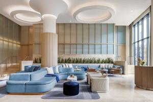 a lobby with blue furniture and large windows at The Morrow Washington Dc, Curio Collection By Hilton in Washington