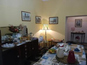 a living room with a table with food on it at Angelina Antica Dimora in Terracina +7 photos