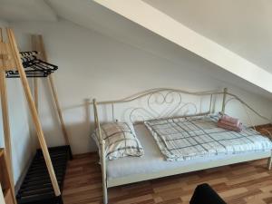 a bedroom with a metal bed and a ladder at Apartments Ivo in Njivice