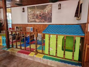 a room with a play area with a wooden fence at Hotel Sunrise in Ravda