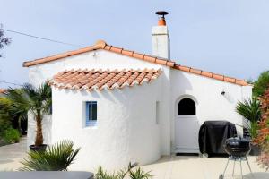um pequeno edifício branco com um telhado vermelho em Jolie Villa à 400m des plages de sable em La Plaine-sur-Mer