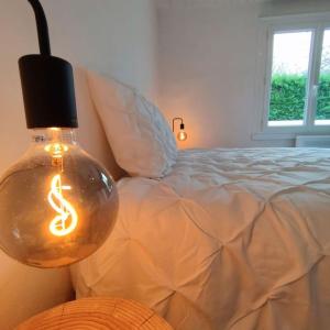 uma lâmpada com um sinal de dólar ao lado de uma cama em Jolie Villa à 400m des plages de sable em La Plaine-sur-Mer