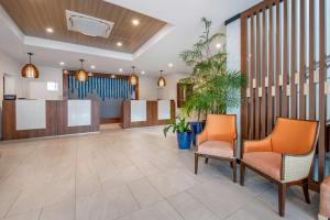 a lobby of a hospital with two chairs and plants at Hilton Vacation Club Flamingo Beach Sint Maarten in Simpson Bay