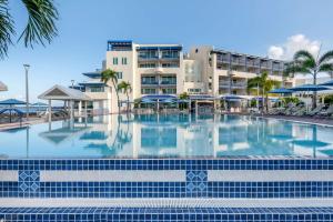 a large swimming pool in front of a hotel at Hilton Vacation Club Flamingo Beach Sint Maarten in Simpson Bay