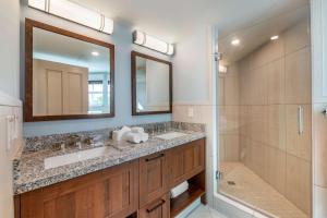 a bathroom with a sink and a shower and a mirror at Hilton Vacation Club Flamingo Beach Sint Maarten in Simpson Bay