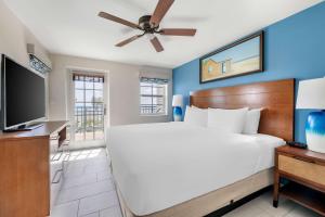 a bedroom with a large bed and a flat screen tv at Hilton Vacation Club Flamingo Beach Sint Maarten in Simpson Bay