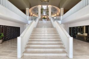 a staircase leading up to a building with wine racks at Domes Lake Algarve, Autograph Collection in Vilamoura