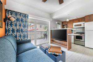 a living room with a blue couch and a kitchen at Hilton Vacation Club Flamingo Beach Sint Maarten in Simpson Bay