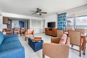 a living room with a blue couch and chairs at Hilton Vacation Club Flamingo Beach Sint Maarten in Simpson Bay