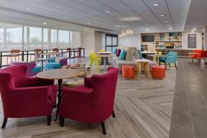 a waiting room with chairs and tables in a building at Home2 Suites By Hilton North Scottsdale Near Mayo Clinic in Scottsdale