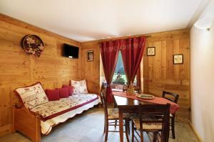 a living room with a couch and a table at Maison Grange 2 in Gressan