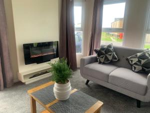 a living room with a couch and a tv at 136, Port Haverigg in Millom