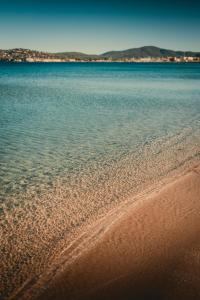 a view of a beach with the water at Les Prairies de la Mer in Grimaud