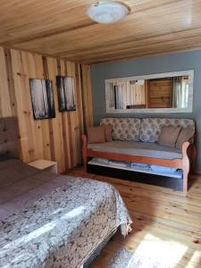una camera con letto e divano di Chalé Bela Vista a Gramado