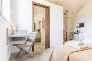 1 dormitorio con cama, escritorio y silla en Casale alle Vigne, en Nardò
