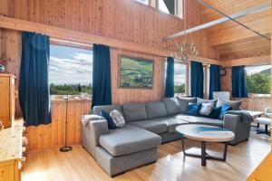 a living room with a couch and a table at Bestefarhaugen - The cozy house on the hill - with a dome in Bø +40 photos