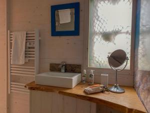 a bathroom with a sink and a mirror at The Surf Shack in Camber