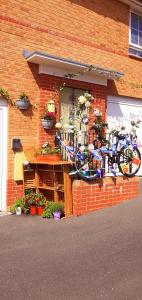 a bike parked against a brick building with plants at Marina,Families are welcome in East Cowes
