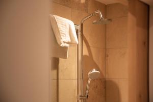 a shower with a shower head in a bathroom at Alpengasthof Filzstein in Krimml