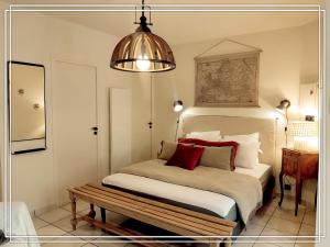 Dormitorio con cama con banco en APPART HOTEL Place des Jolis Rêves, en Riom-ès-Montagnes 71 fotos más