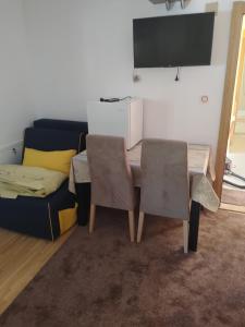 a living room with a table and a couch at Vila Sipovac in Budva