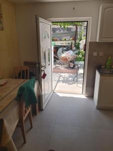 a kitchen with a door leading to a yard at Vila Sipovac in Budva +1 photo