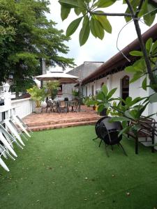 a yard with chairs and tables and a patio at Le Meilleur in George Town
