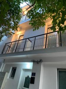 a white building with a balcony on top of it at LamijaApartmani in Sutomore