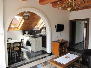 a living room with an archway with a fireplace at Zrínyi ház in Szántód